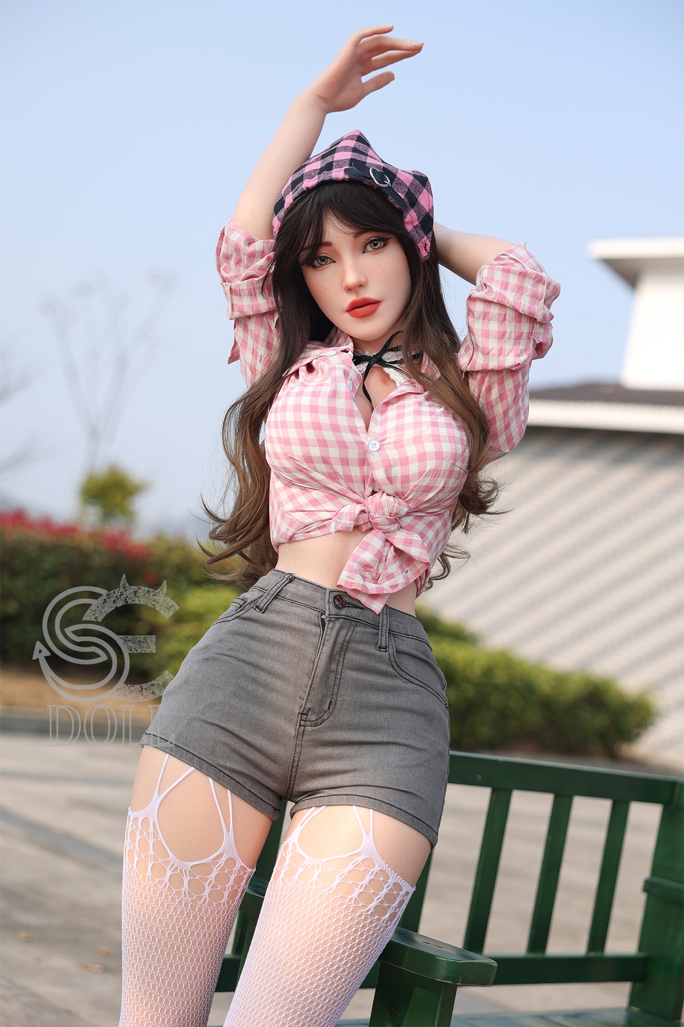 Sexy love doll in pink checkered shirt and shorts, outdoors look