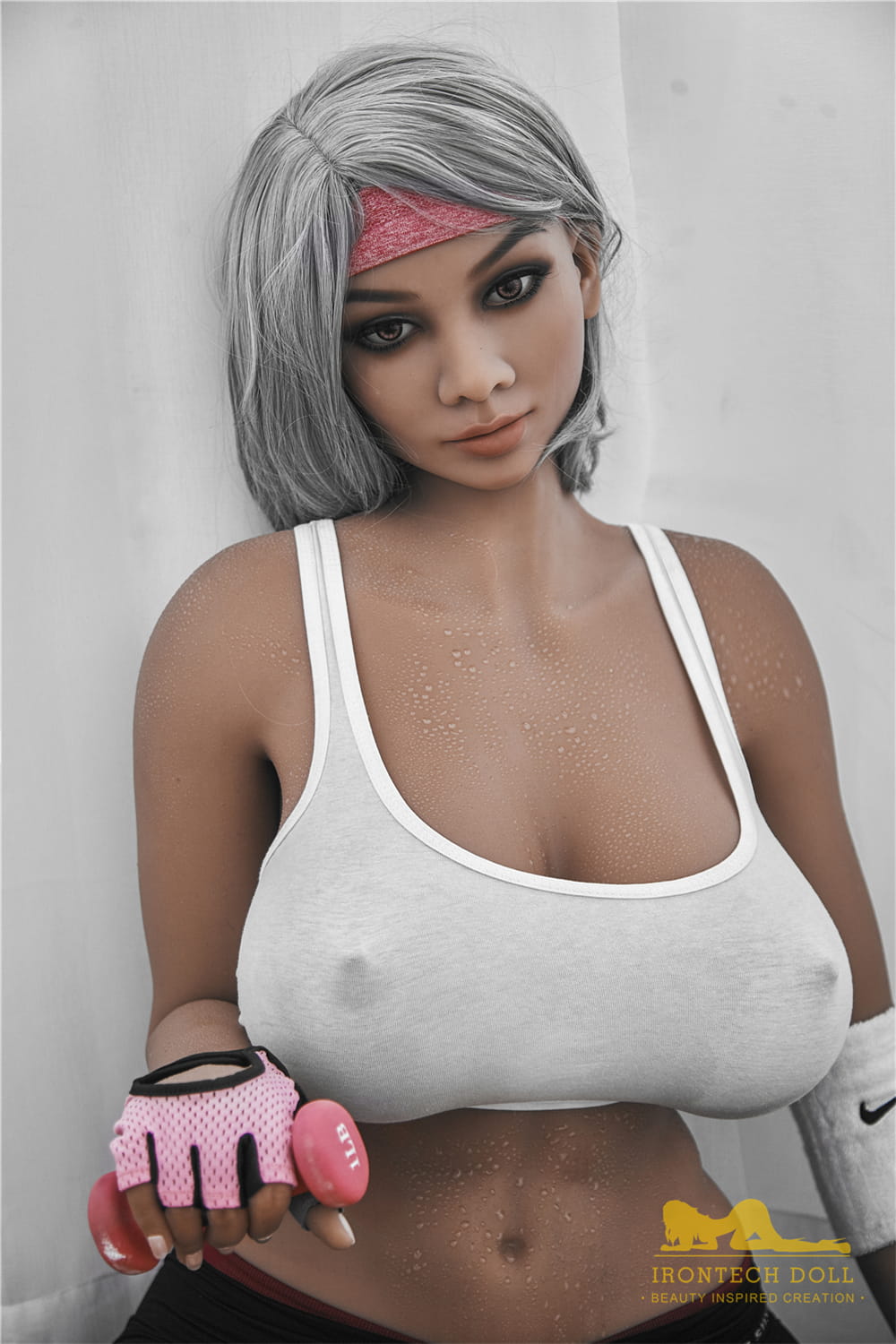 The beautiful breasts of an athletic young woman at the gym. A fit sex doll from dollslovers.com